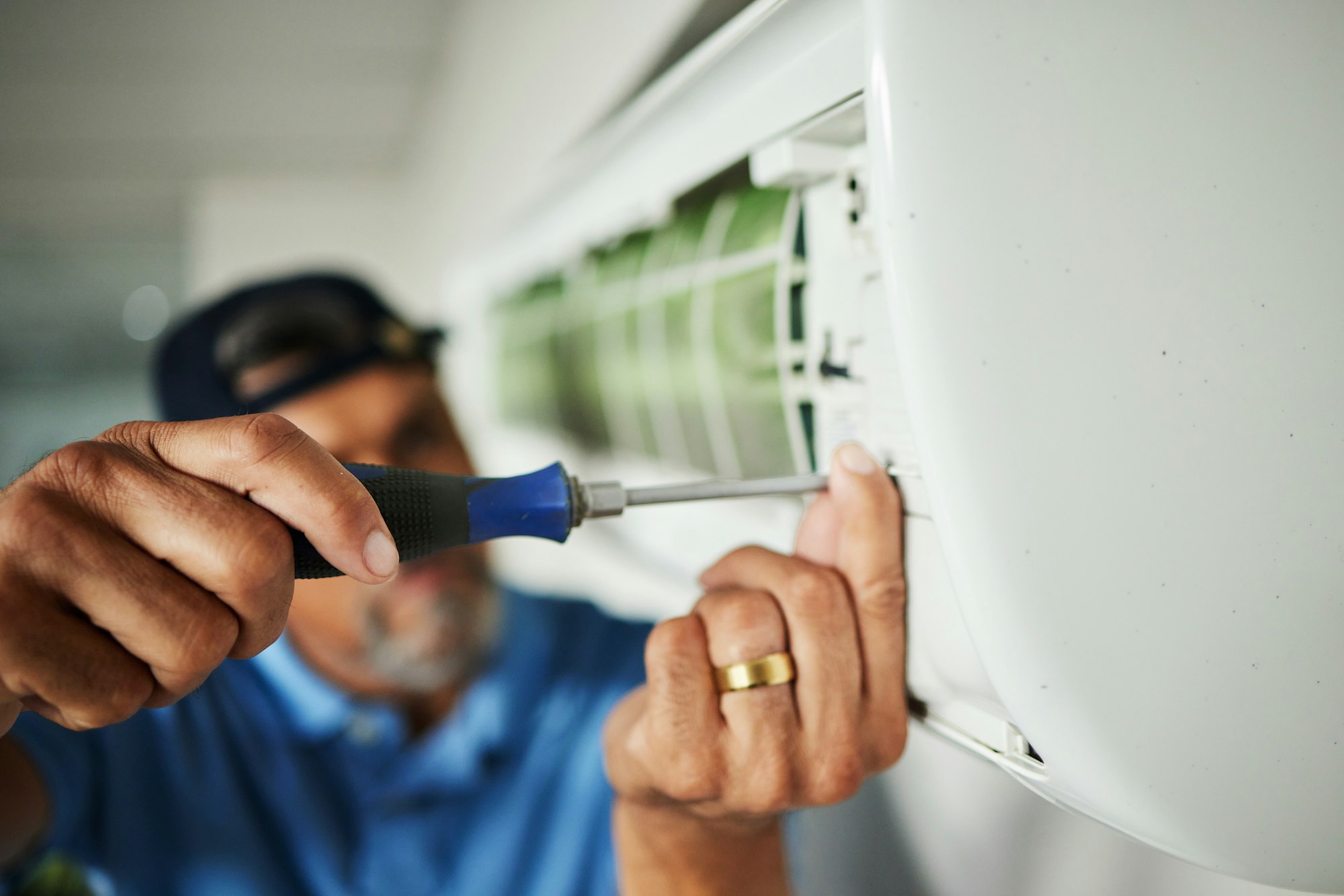 Electrician, hands and air conditioning with man and screwdriver for maintenance, ventilation or po