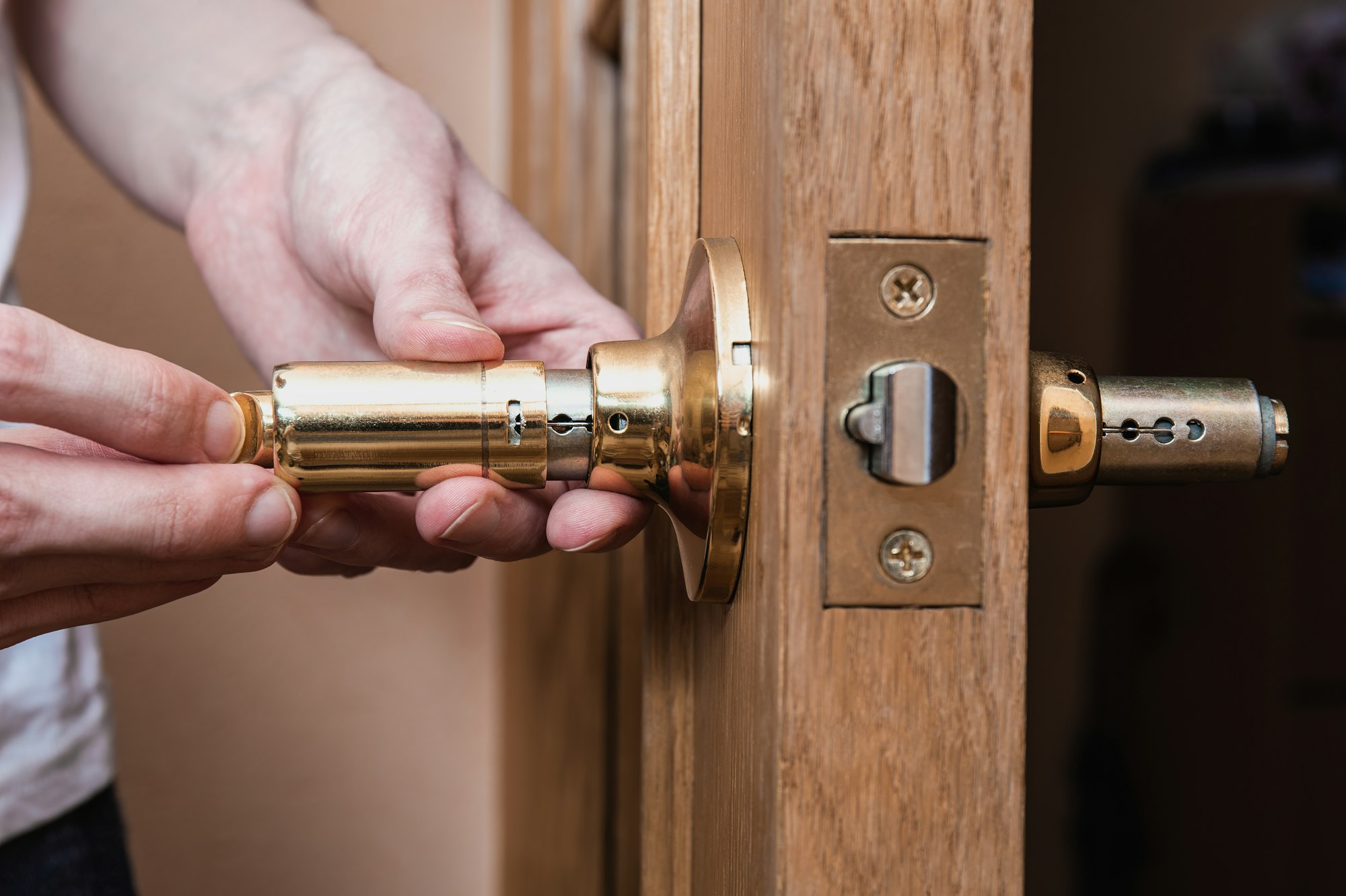 locksmith carpenter fix knob on wooden door by screwdriver for home service reparation. locksmith carpenter fix knob on wooden door by screwdriver for home service reparation.